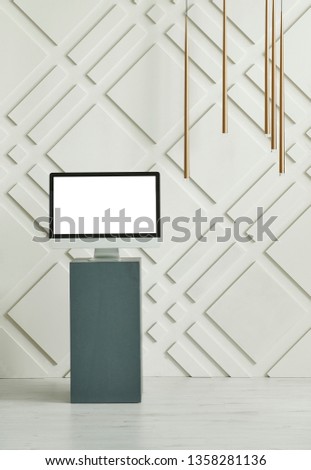 Decorative wall background, dark blue table, laptop and computer decor, vase of plant and lamp style.