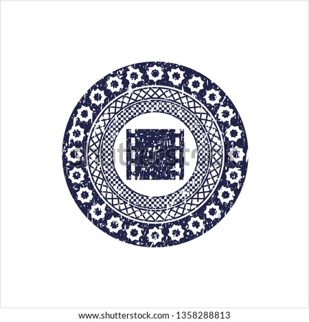 Blue film icon inside distress rubber stamp with grunge texture