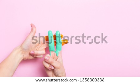 female hands in paint crossed in a hashtag sign on a colored background, creative advertising, social networks concept