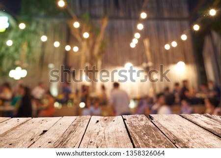 Empty old table wooden texture on
Abstract blur image customer dinner hang out or enjoy in the restaurants  and The atmosphere is happy and relaxing with bokeh./ Ready For montage product display