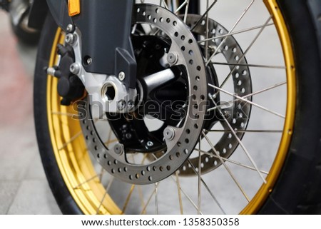 Disc brake with wheel hub on motorbike. Close up of front disc brake on motorcycle. Motorcycle car care and maintenance concepts. - Selective focus.