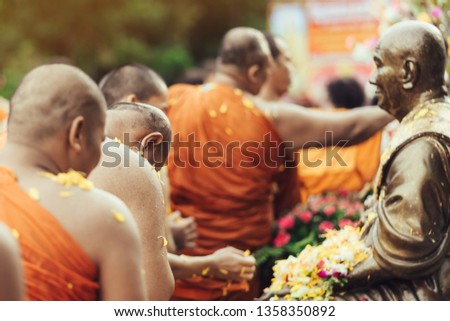 Group of Monks bath Buddha 
sculpture purify body and spirit in Songkran festival, Thailand