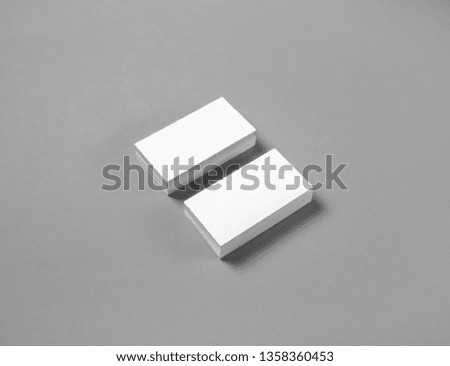 Blank business cards mockup on gray paper background. Copy space for text.