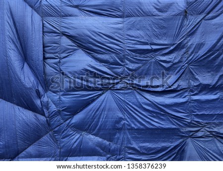 picture of old torn blue wrinkled sail background