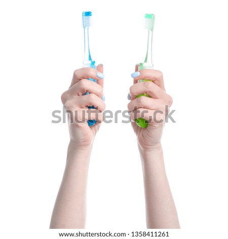 Two toothbrushes in hand on white background isolation