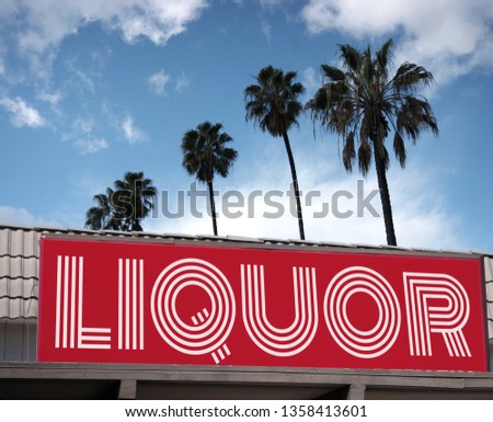 Aged and worn liquor store sign with palm trees