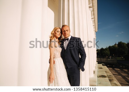 Wedding in greece. Couple look to each other and smile. Blonde hair bride fall in love
