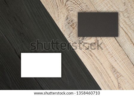 Blank business cards on the Black wooden table. Template for ID. Top view