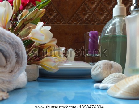 Close-up pictures of objects, spa themes on a carved wooden background. And blue glazed tiles
