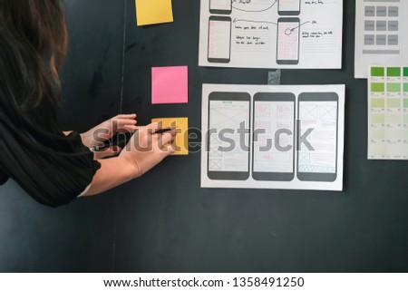 Graphic designers creative drawing website ux app development and application for mobile phone in the office.