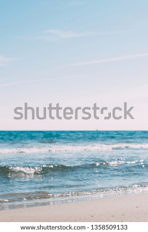 Summer sand beach and seashore waves background. Defocused holiday vacations concept backdrop for motivational quotes, blog posts, your text
