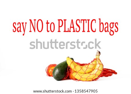isolated cotton net bags for shopping full of fruits on white background. concept of zero waste . 