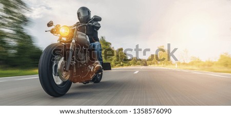 motorbike on the forest road riding. having fun driving the empty road on a motorcycle tour journey. copyspace for your individual text.  Royalty-Free Stock Photo #1358576090