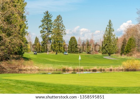 Golf course with gorgeous green and small pond view