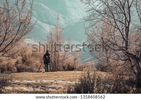 Young Lady Photographer With Backpack Standing On Top Of The Mountain - image