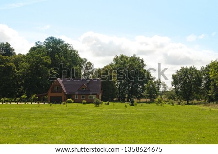 Idyllic house in village with green lawn