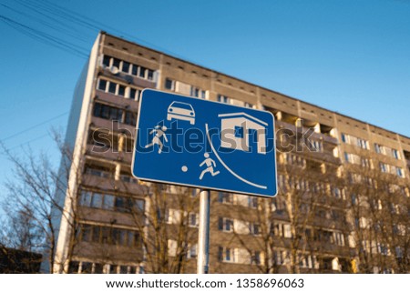 Living sector european road sign in Riga, Latvia with a typical soviet block of flats house building in the background
