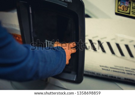 Asian women hand and finger buying and pressing water vending machine.