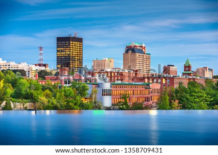 Manchester, New Hampshire, USA Skyline on the Merrimack River at dusk. Royalty-Free Stock Photo #1358709431