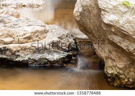 The water flows through the rocks in a beautiful stream.