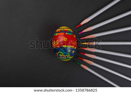 Painted egg on black background. Easter concept.