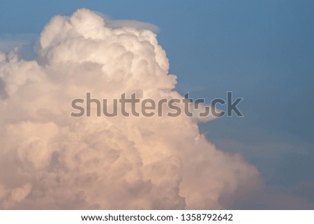 A pattern of white cloud in beautiful blue sky. The cloud pattern is fluffy like heaven. This picture was shot in evening sunset. It can be used as background. Nature and peaceful summer concept.