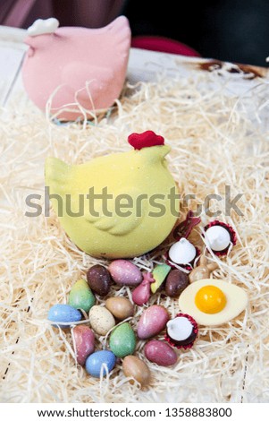 Easter chocolate hen and eggs with candies and bonbons