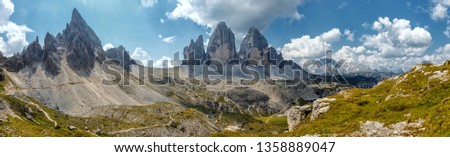 Great sunny view of the National Park Tre Cime di Lavaredo, Panoramic view of three spectacular mountain peaks. Awecome nature landscape. Hiking, Family on hike, Tre Cime di Lavaredo. Dolomite. Italy