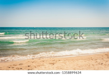 View from the beach of Catania, Sicily, Italy, Lido Cled with the green windsurf board in the sea