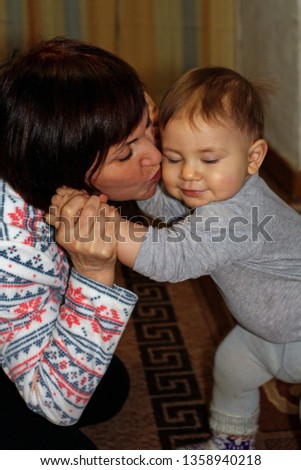 grandmother kisses her grandson