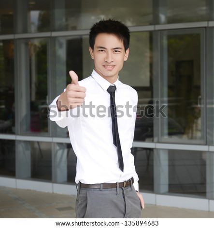 young business man giving you a positive success sign