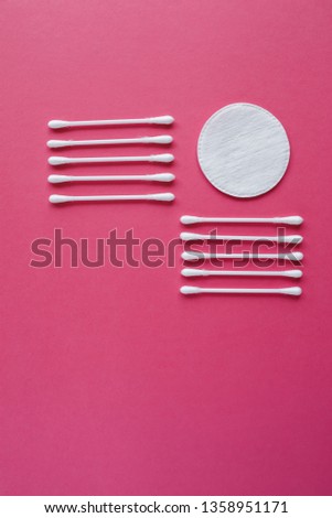 Cotton swabs and disks isolated on a pink background. Hygiene products