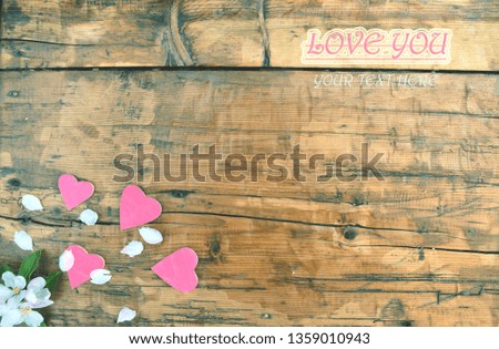 Hearts and petals on a wooden table