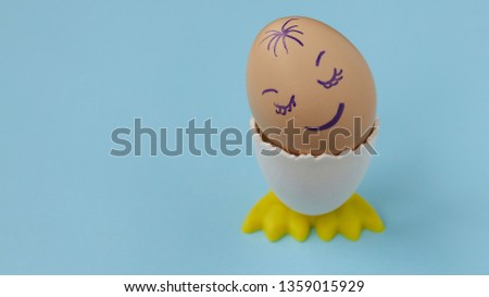 White chicken egg sleeping with happy face on the blue background