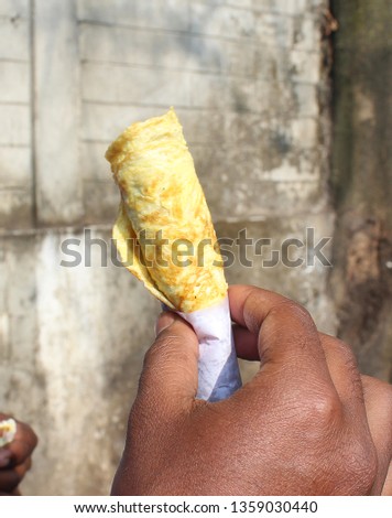 Egg Roll With Hand Stock Photo