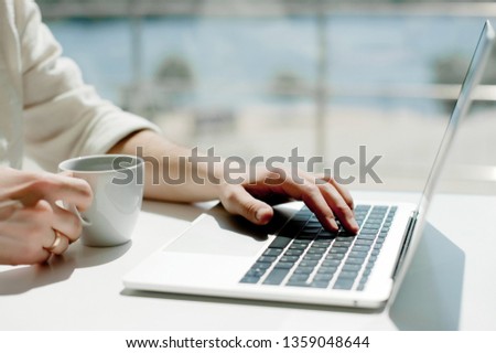 Lifestyle education student. Businessman work on laptop for project. Millennial at home office drink coffee looking for job on notebook. Unrecognizable man using modern portable computer and phone.