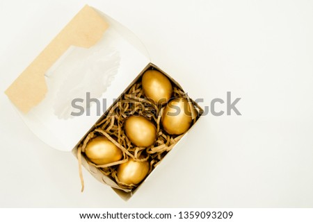 Easter golden eggs on white background. Minimal easter concept.  Card with copy space for text. Top view, flatlay, several objects