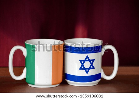 Israel and Ireland flag on two cups with blurry background
