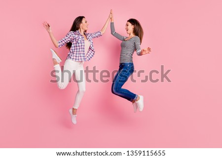 Profile side view full length body size photo of excited energetic teens teenagers enjoying laughing wearing checked shirts jeans having stroll screaming isolated on pink background