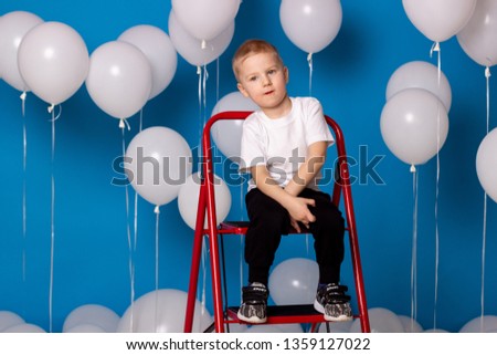 A child with lots of balloons.