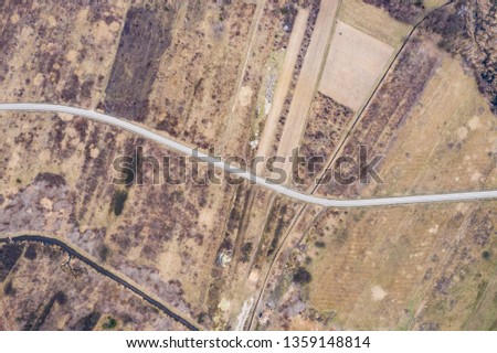 Aerial above view of a rural landscape with a road running. Drone photography