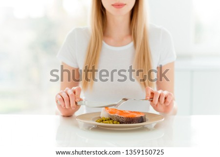 Portrait of charming cute attractive lady have dinner lunch full of protein use fork knife silverware taste hungry want eat dressed in modern stylish clothes sit in fashionable apartment