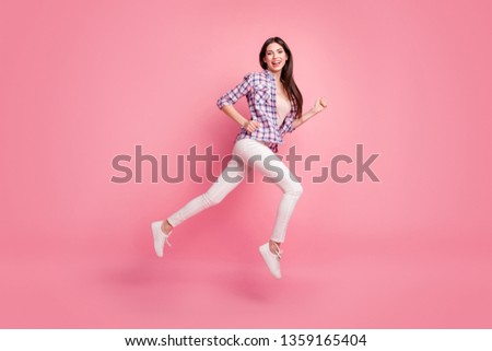 Full length side profile body size photo beautiful her she model lady jump high go running sale discount wear shoes casual checkered plaid shirt white jeans denim clothes isolated pink background