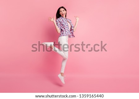 Full length side profile body size photo amazing beautiful her she lady jump high party holiday wear shoes casual checkered plaid shirt white jeans denim clothes outfit isolated pink background