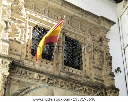 Spanish flags flying above the buildings in a Seville square, Spain