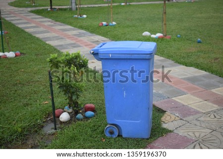 Blue colour dustbin in a park for clean outdoor and environment 