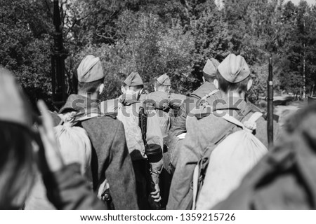 Re-enactors Dressed As World War II Russian Soviet Red Army Soldiers Marching Through Forest. Photo In Black And White Colors. Soldier Of WWII WW2 Times.