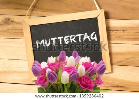 Blackboard, flowers and German translation for mother's day