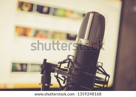 Audio recording vocal studio voice microphone with anti shock mount and built in anti pop filter for singing and voiceover actors doing voiceovers.