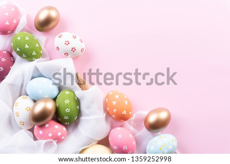 Happy easter! Colorful of Easter eggs in nest with flower and Feather on bright pink  pastel paper background.